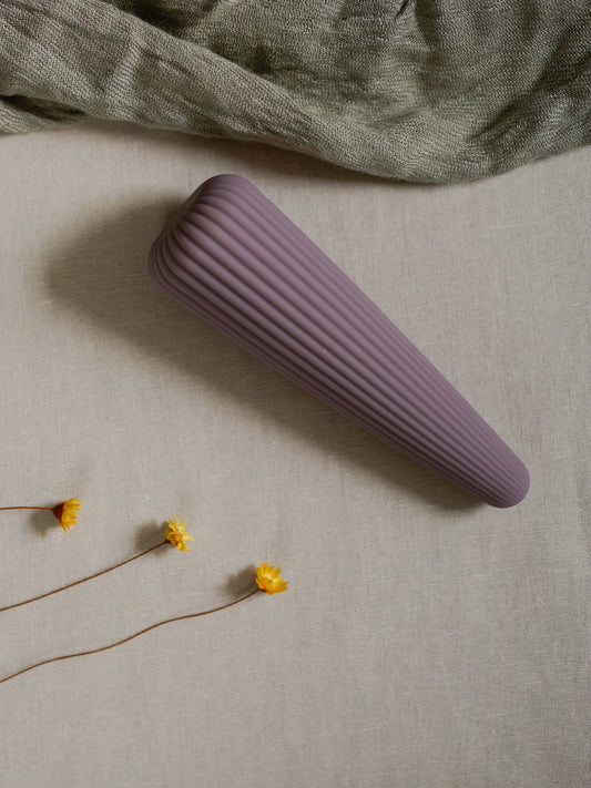 Ambrette wand vibrator has a conical form with buttery soft ribbed silicone for added sensation. It fits beautifully in your palm, making it not just more ergonomic and comfy to hold but you can be much more dexterous and precise with how you pleasure yourself with it.